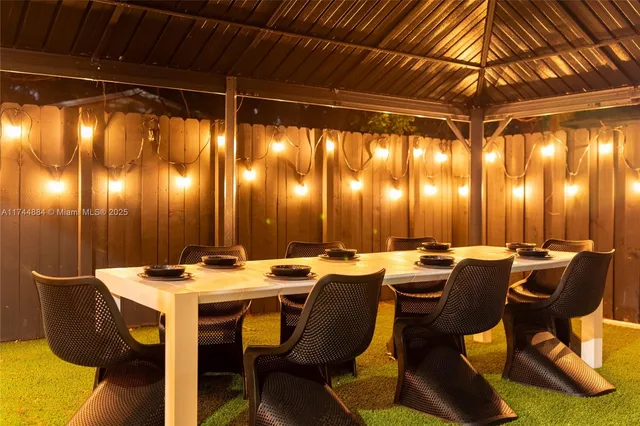 a view of a chair and tables in the back yard of the house