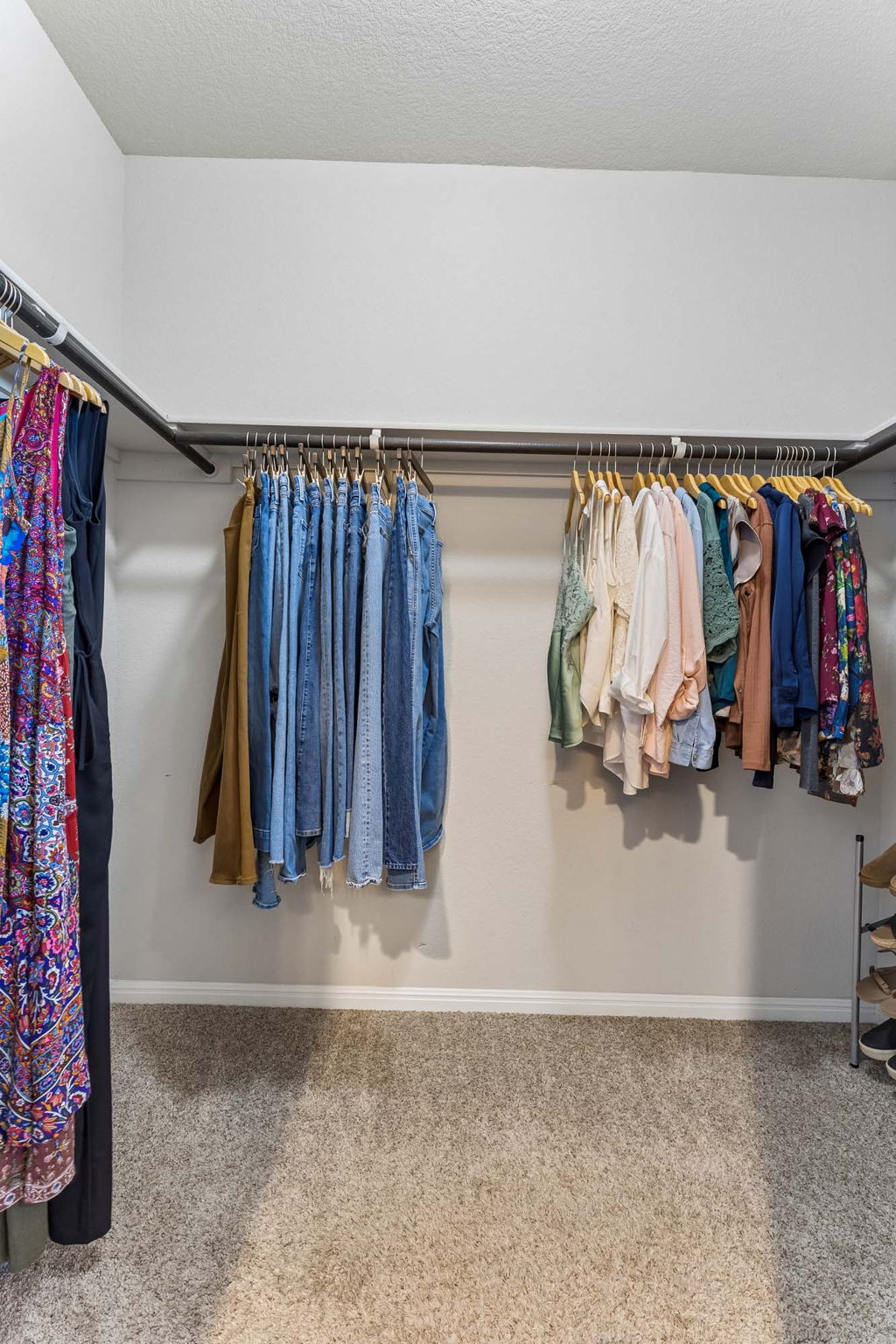 124 Moravia Road Georgetown, TX 78626 - Photo 14 of 38 Ample hanging rods and soft carpeting define this functional walk-in closet space.