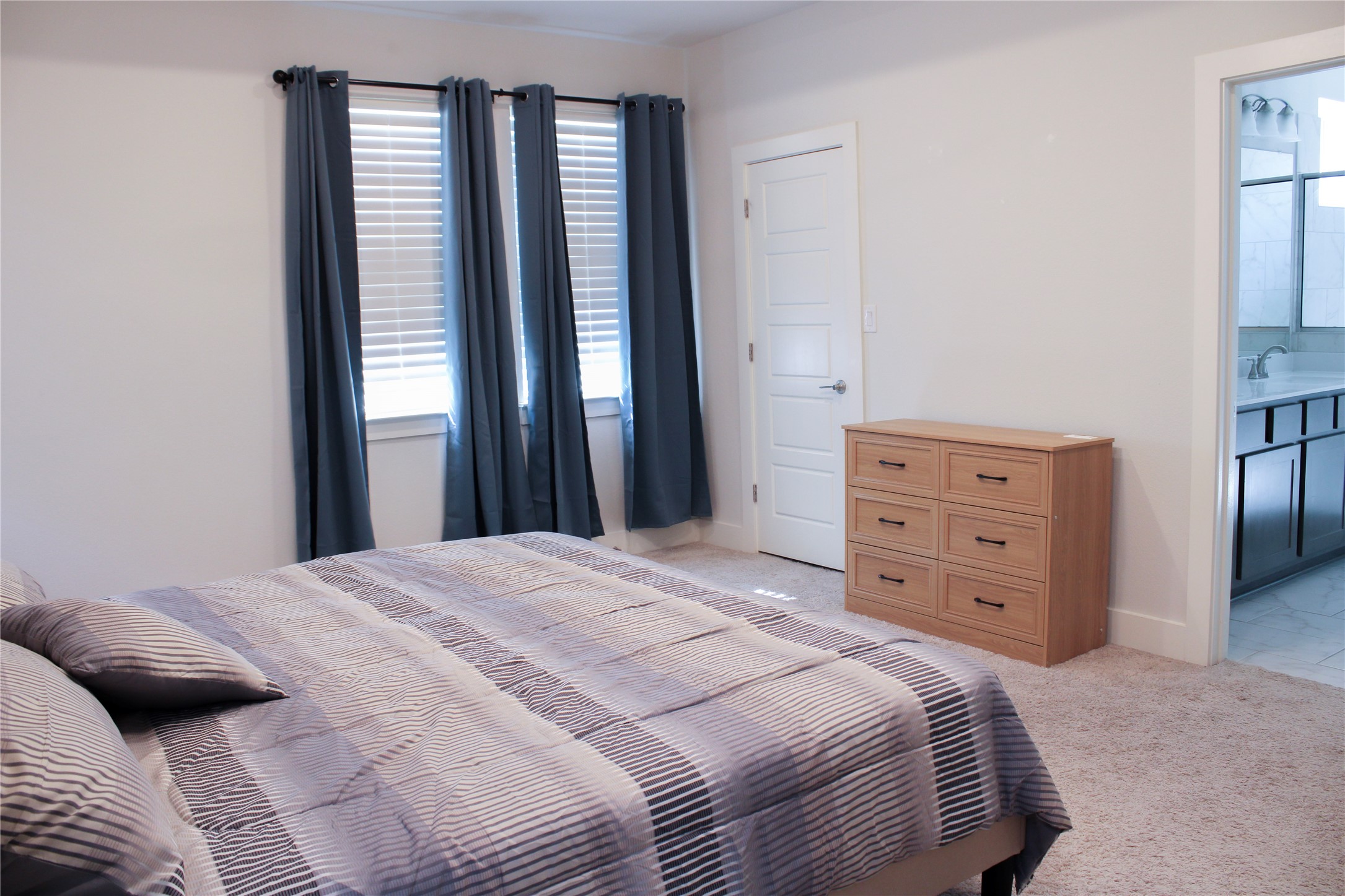 1007 Harwell Loop Kyle, TX 78640 - Photo 25 of 40 a bedroom with a bed and a mirror