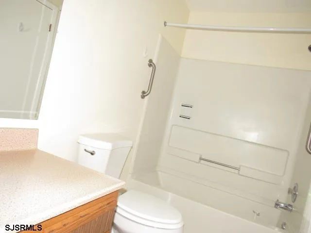 a bathroom with a shower and a toilet