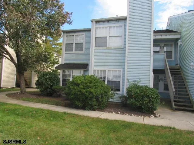 a view of a house with a yard and plants