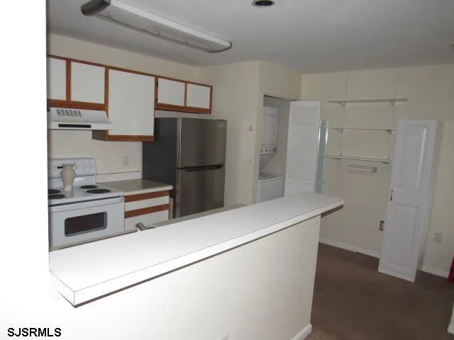 a kitchen with a refrigerator and a stove