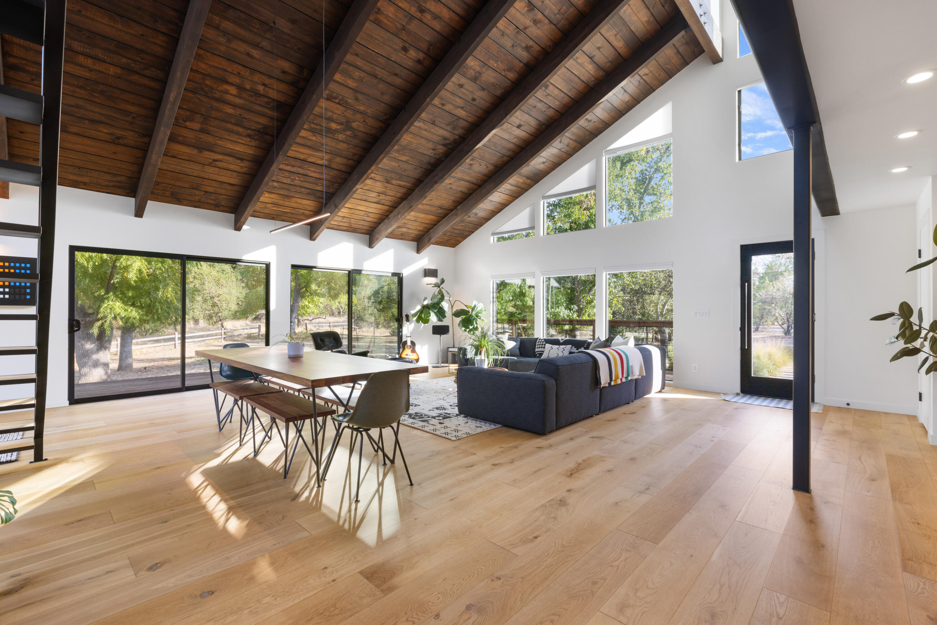 23204 Placid Road Palo Cedro, CA 96073 - Photo 17 of 71 a living room with furniture a wooden floor and a floor to ceiling window