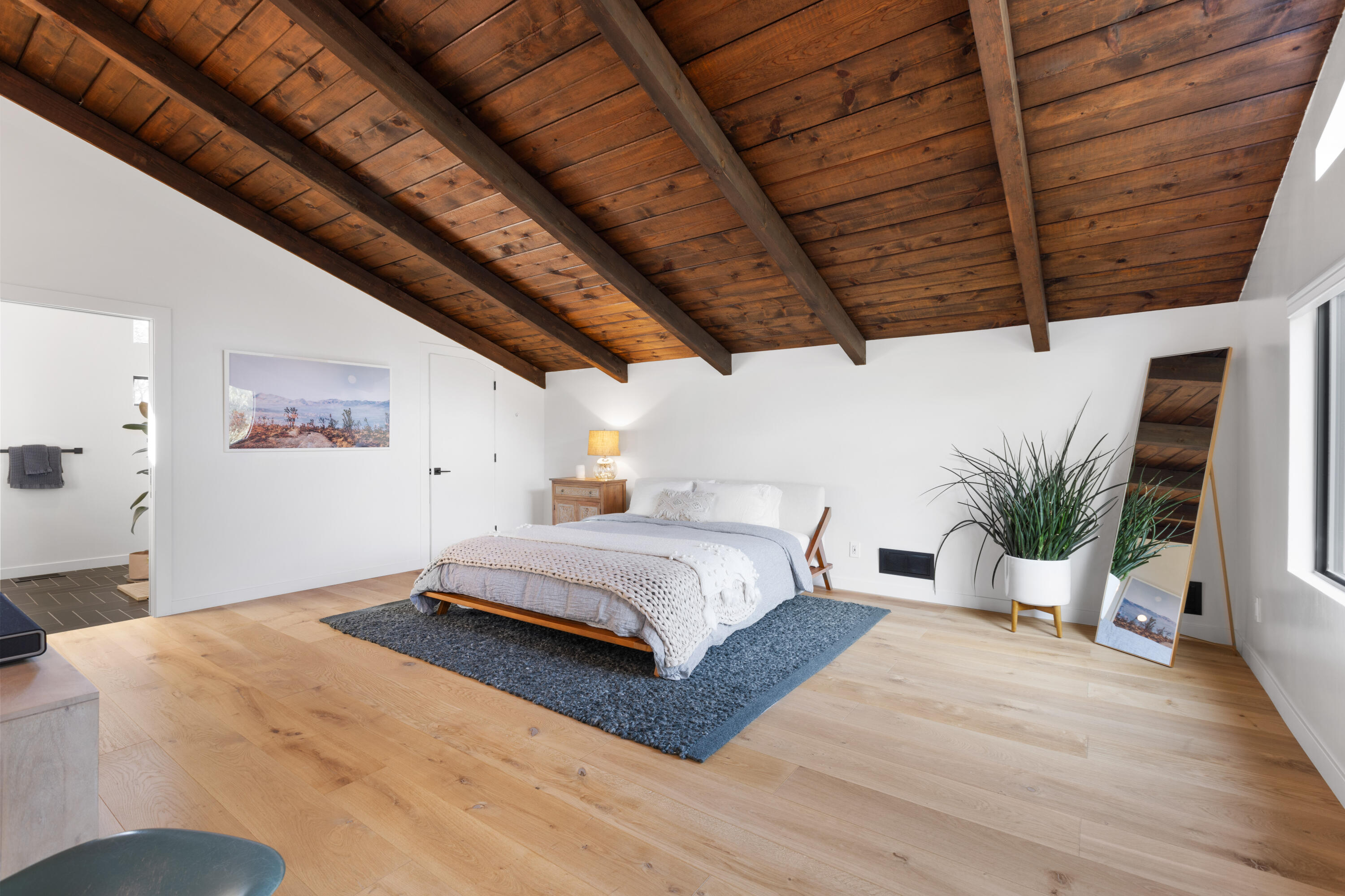 23204 Placid Road Palo Cedro, CA 96073 - Photo 19 of 71 a spacious bedroom with a bed and a potted plant