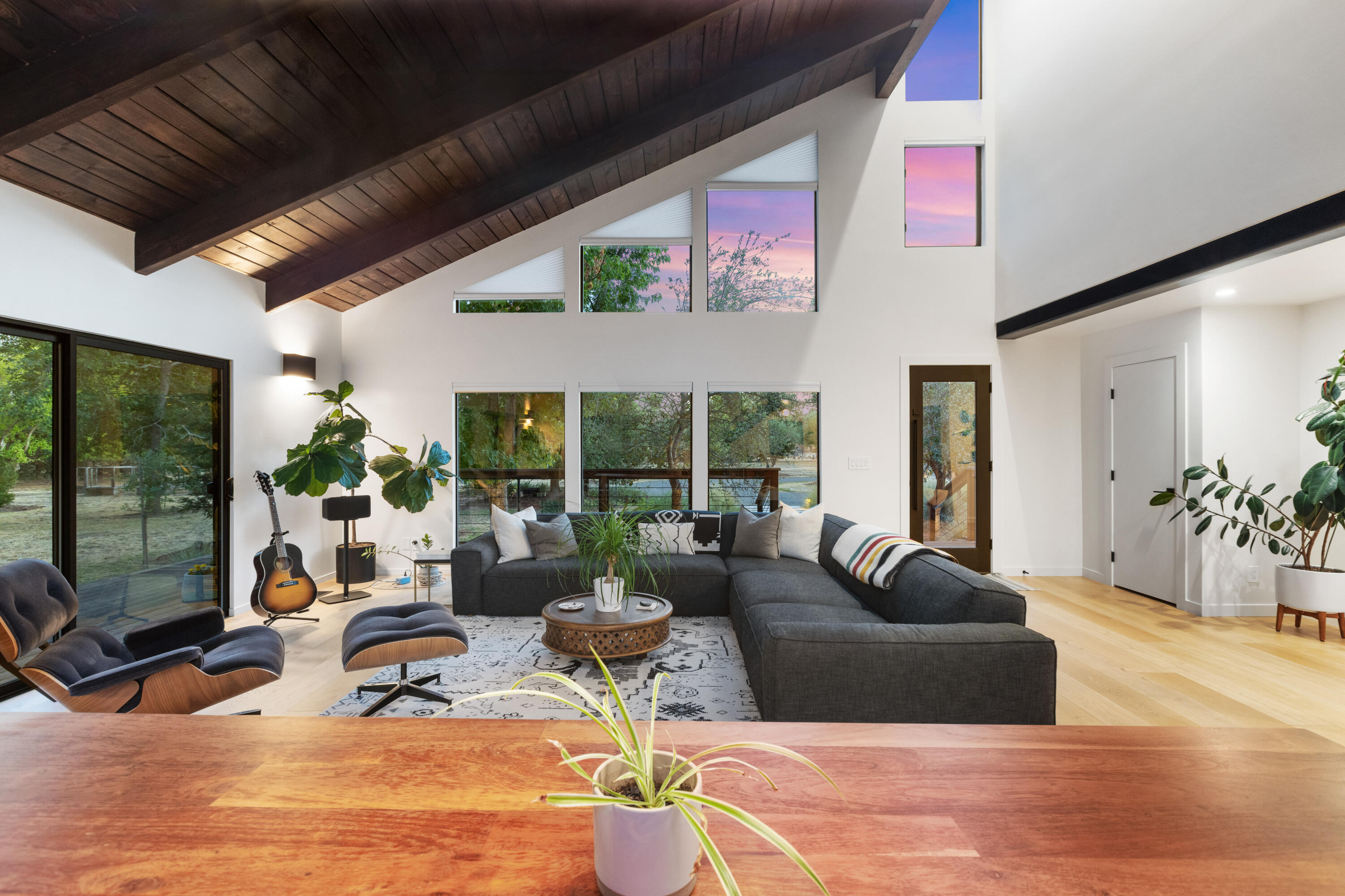 23204 Placid Road Palo Cedro, CA 96073 - Photo 41 of 71 a living room with furniture a floor to ceiling window and potted plants