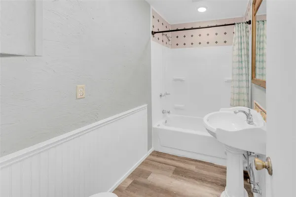 a bathroom with a bathtub and a shower