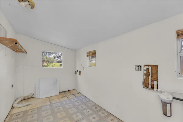 a view of a storage & utility room with a window
