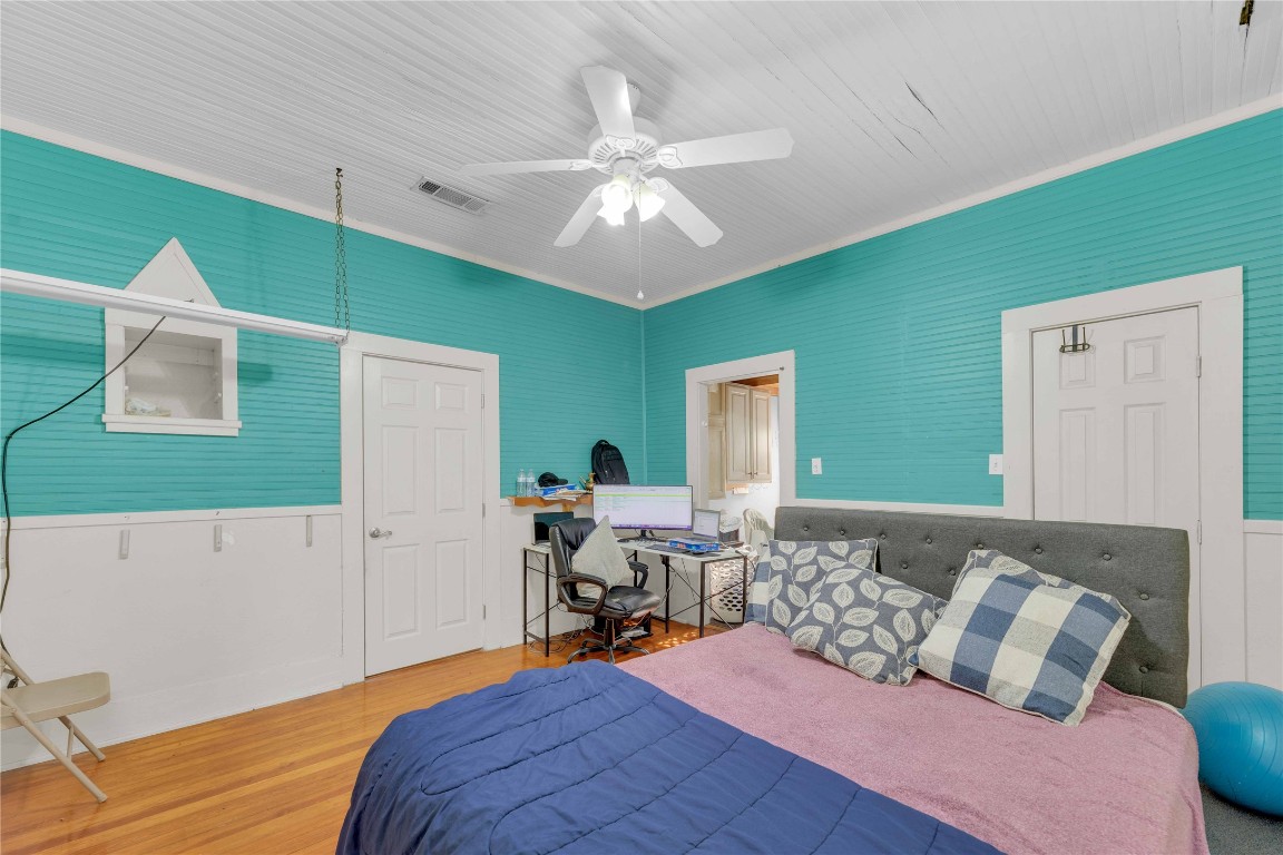 20235 Engelmann Lane Manor, TX 78653 - Photo 24 of 34 a bed room with a bed and a chandelier