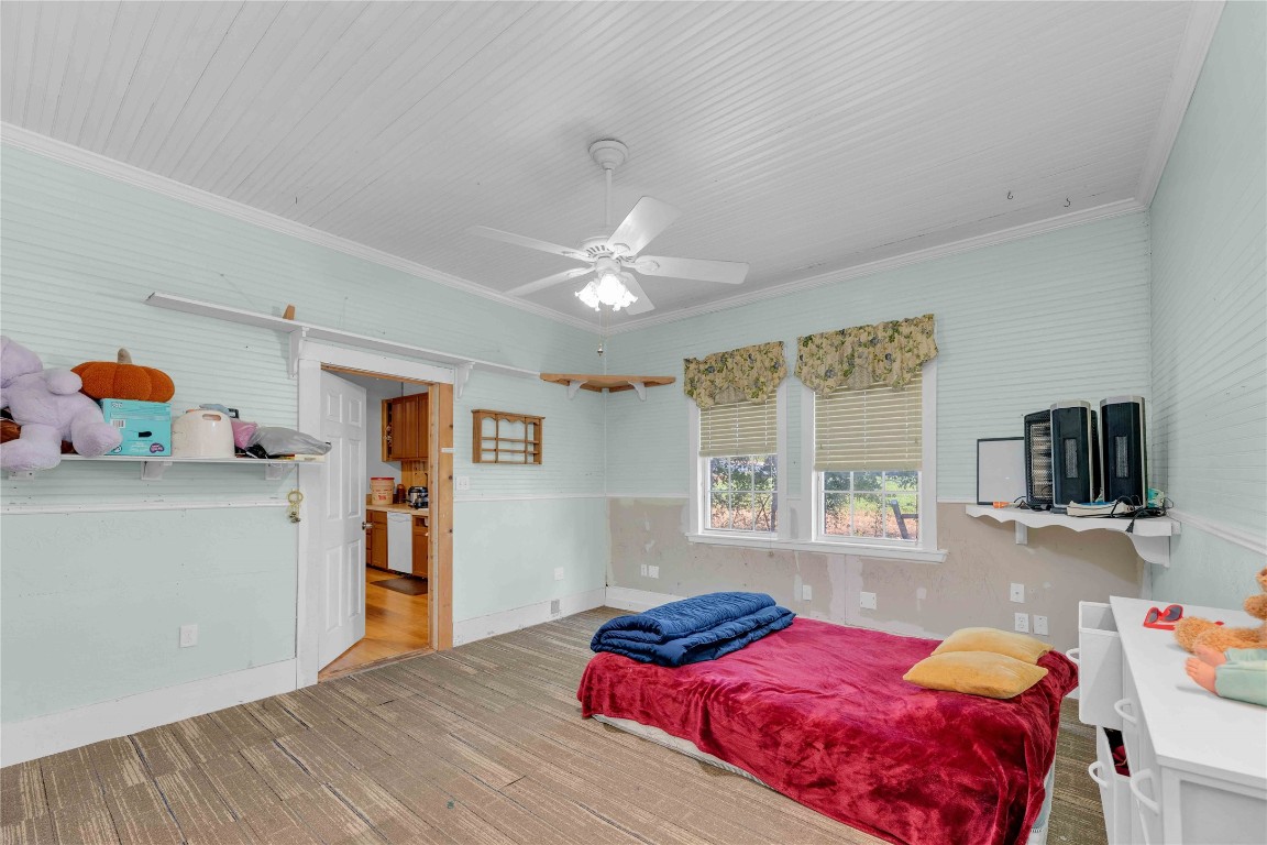 20235 Engelmann Lane Manor, TX 78653 - Photo 25 of 34 a bedroom with a bed and large windows