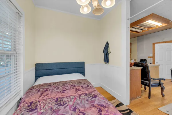 a bedroom with a bed and a chandelier