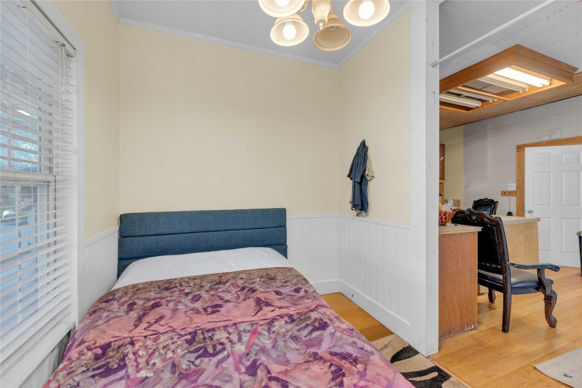 20235 Engelmann Lane Manor, TX 78653 - Photo 29 of 34 a bedroom with a bed and a chandelier