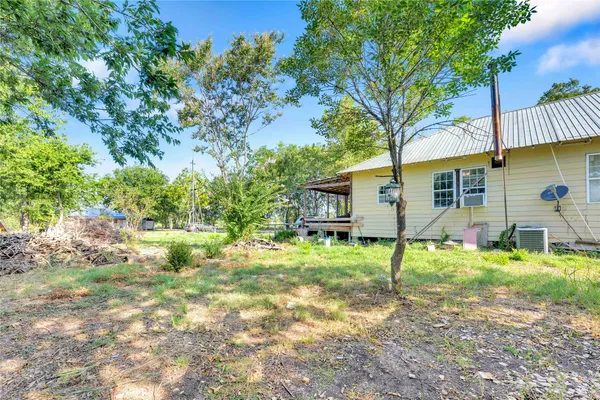a backyard of a house with table and chairs