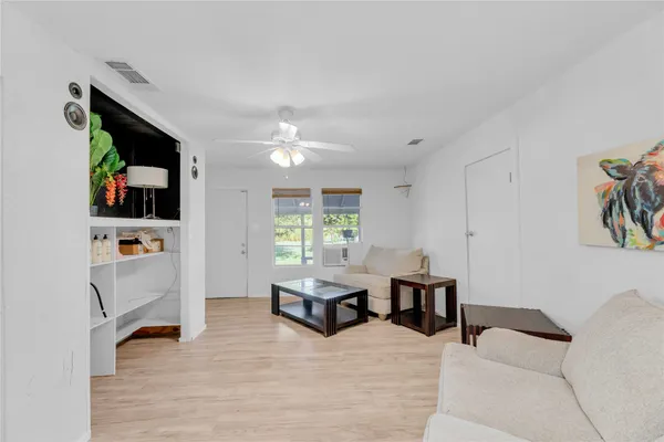 a living room with furniture and flat screen tv