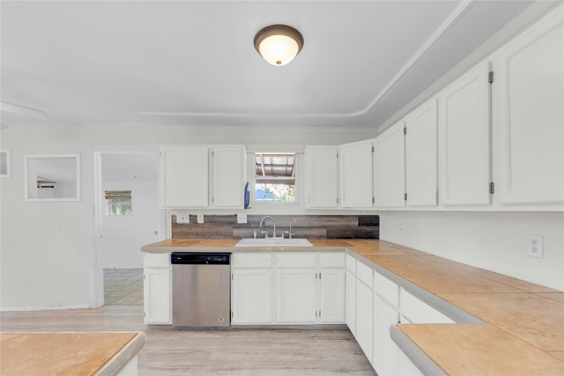 20235 Engelmann Lane Manor, TX 78653 - Photo 7 of 34 a kitchen with granite countertop a sink a stove a microwave and cabinets