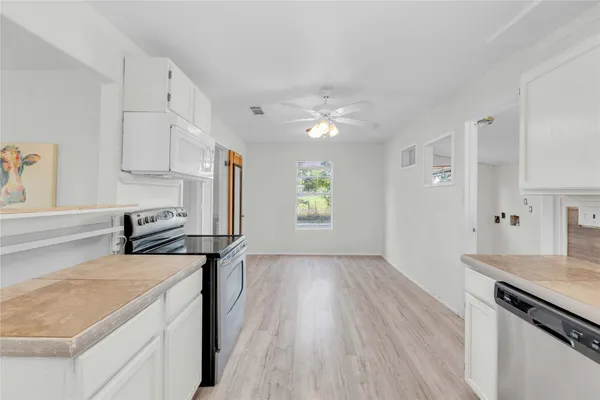 a kitchen with a stove a sink and a refrigerator