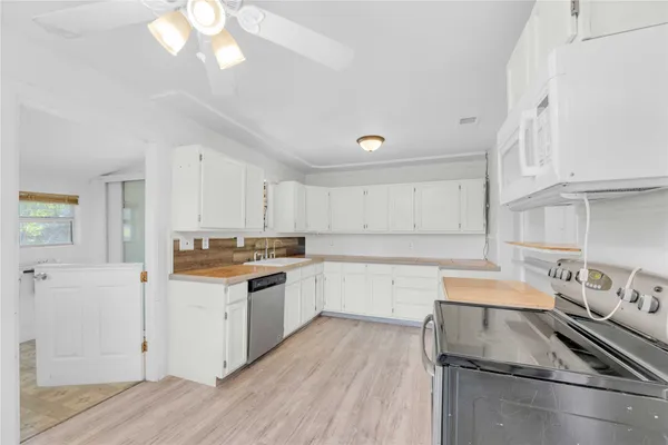a kitchen with a sink stove and cabinets