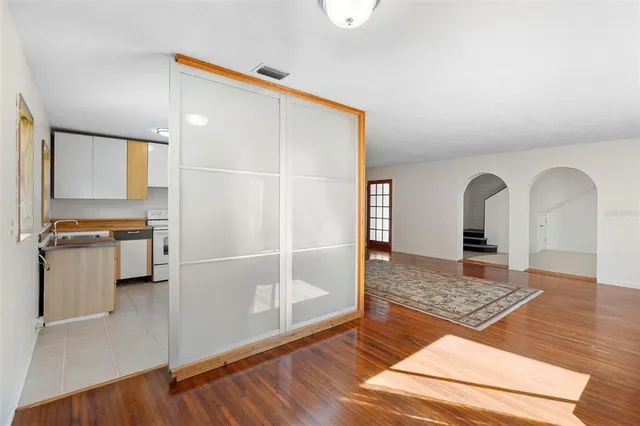 a view of empty room with wooden floor