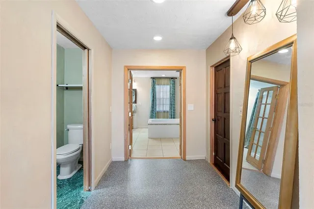 a bathroom with a tub a sink and a large mirror