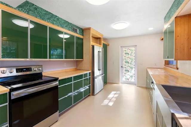 a kitchen with a sink stove and microwave