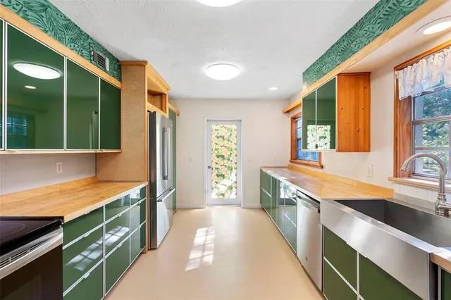 a kitchen with stainless steel appliances granite countertop a sink and a stove
