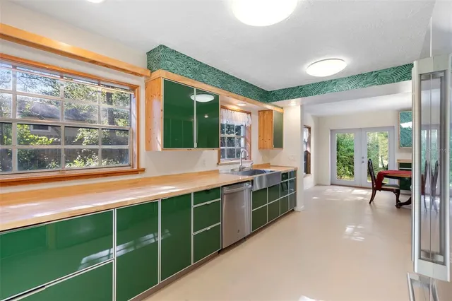 a large white kitchen with a large window