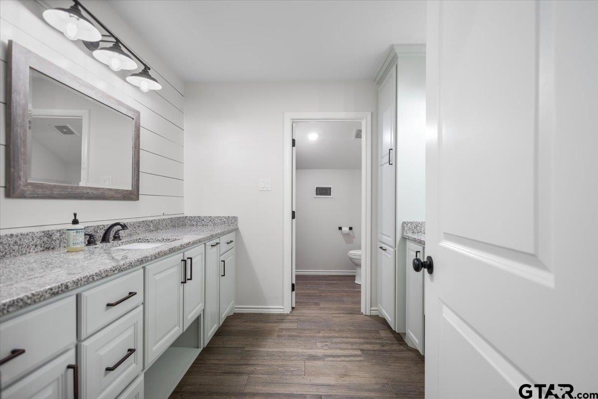 9235 Farm To Market Road 851 Rusk, TX 75785 - Photo 34 of 47 a spacious bathroom with a granite countertop sink and a mirror