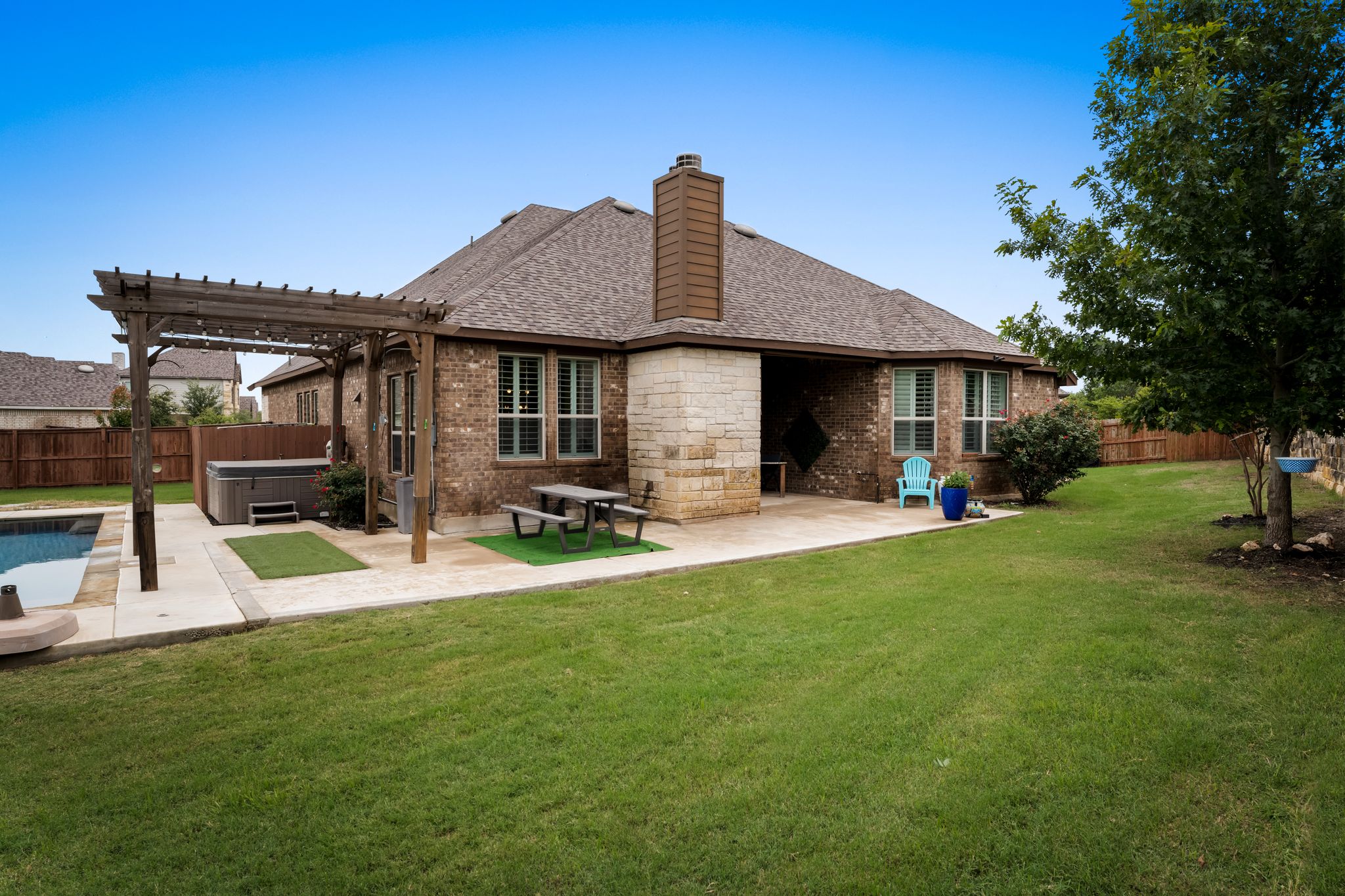 140 Waterloo Cove Georgetown, TX 78628 - Photo 34 of 40 A private oasis awaits with a sparkling salt water pool and spa, alongside an inviting covered patio for entertaining.