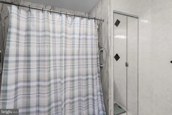 a bathroom with a shower curtain and a curtain