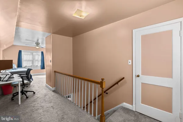 a view of a hallway with workspace and entryway