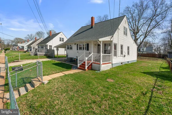 a view of a house with a yard and sitting area
