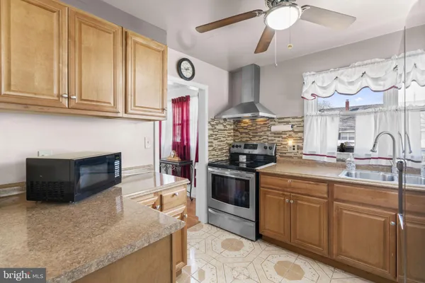 a kitchen with stainless steel appliances granite countertop a stove and a sink