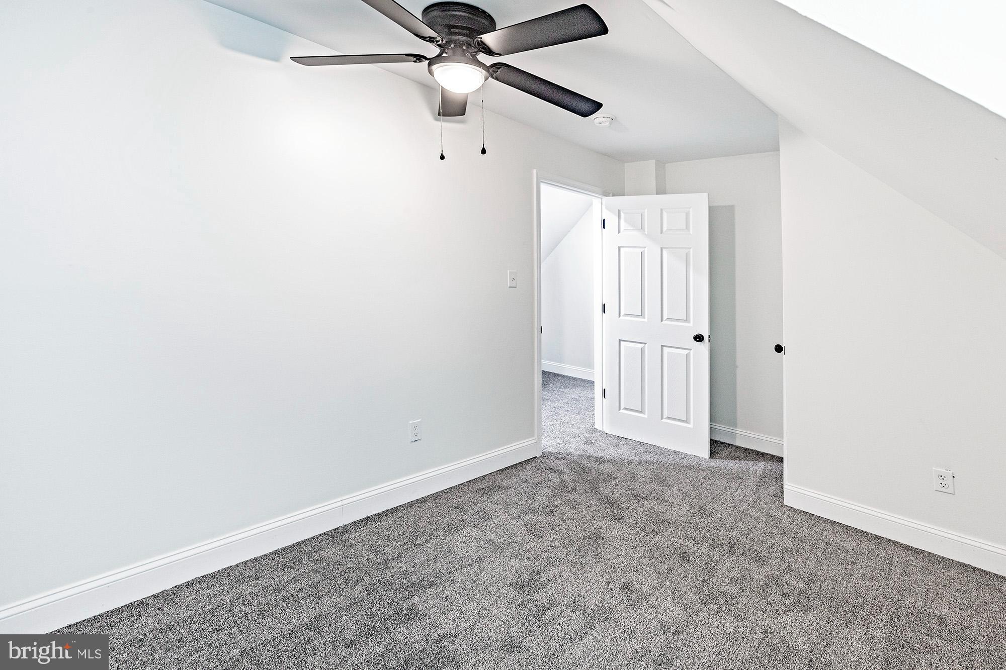 111 Grove Street Penns Grove, NJ 08069 - Photo 15 of 27 an empty room with a ceiling fan and carpet