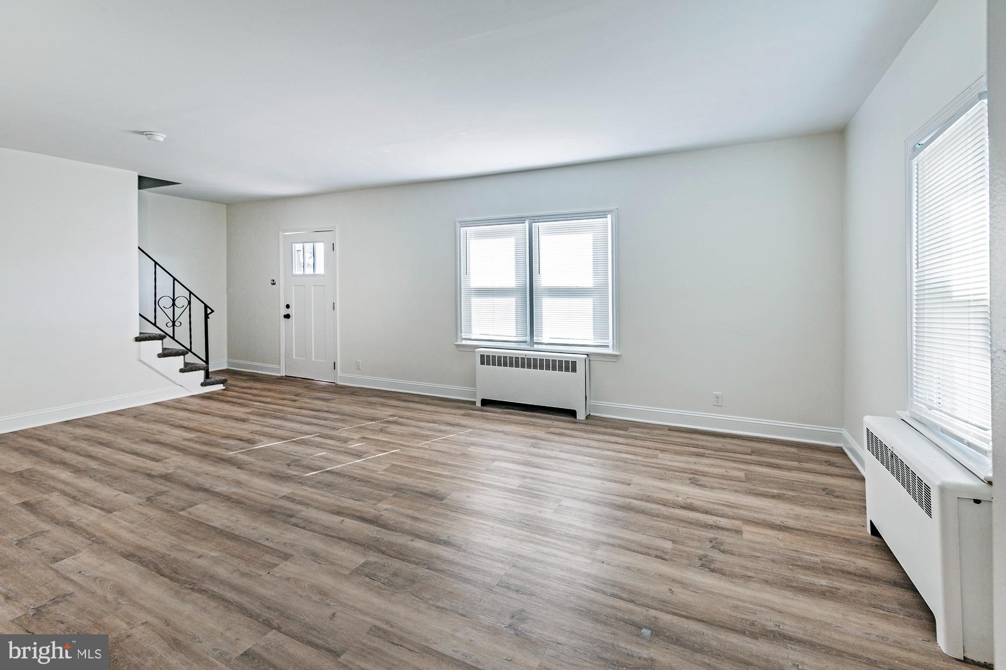 111 Grove Street Penns Grove, NJ 08069 - Photo 5 of 27 a view of empty room with wooden floor and fan