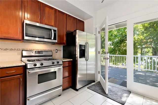 a kitchen with a stove a microwave and refrigerator