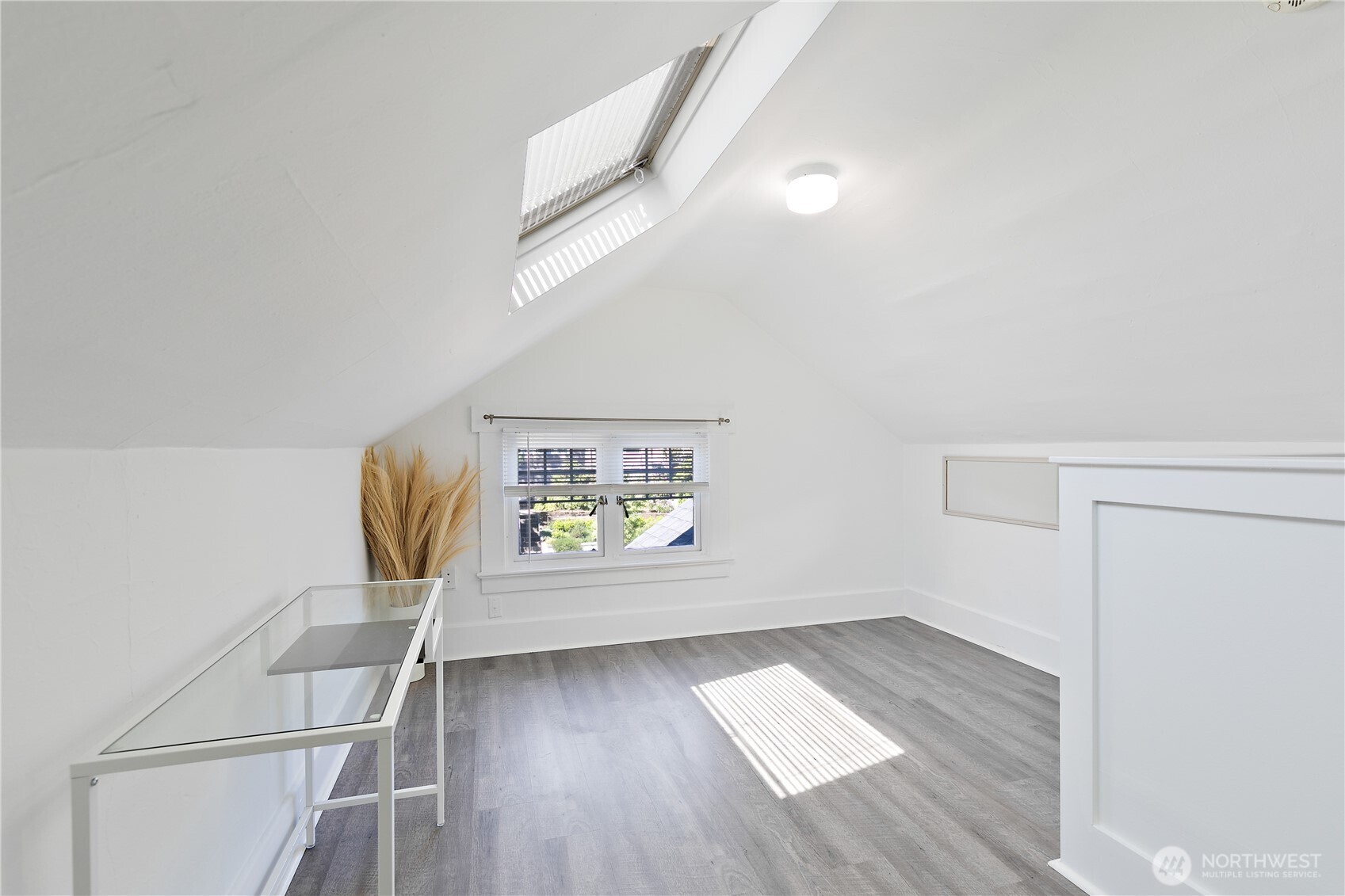 6540 19th Avenue Northeast Seattle, WA 98115 - Photo 15 of 40 a view of hallway with window and wooden floor