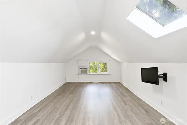 a view of room with wooden floor and window