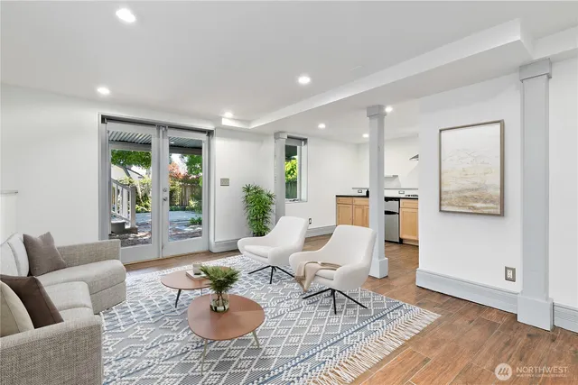 a living room with furniture and a wooden floor