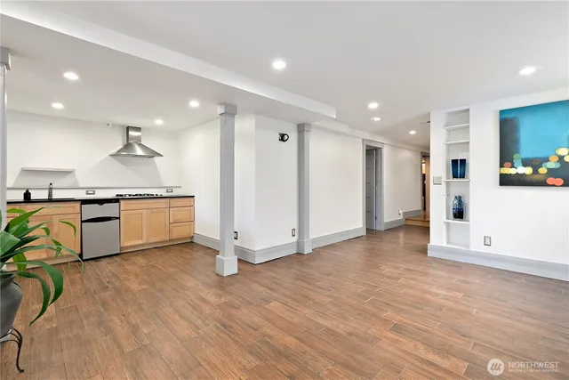 a view of kitchen with stainless steel appliances granite countertop a stove and a refrigerator