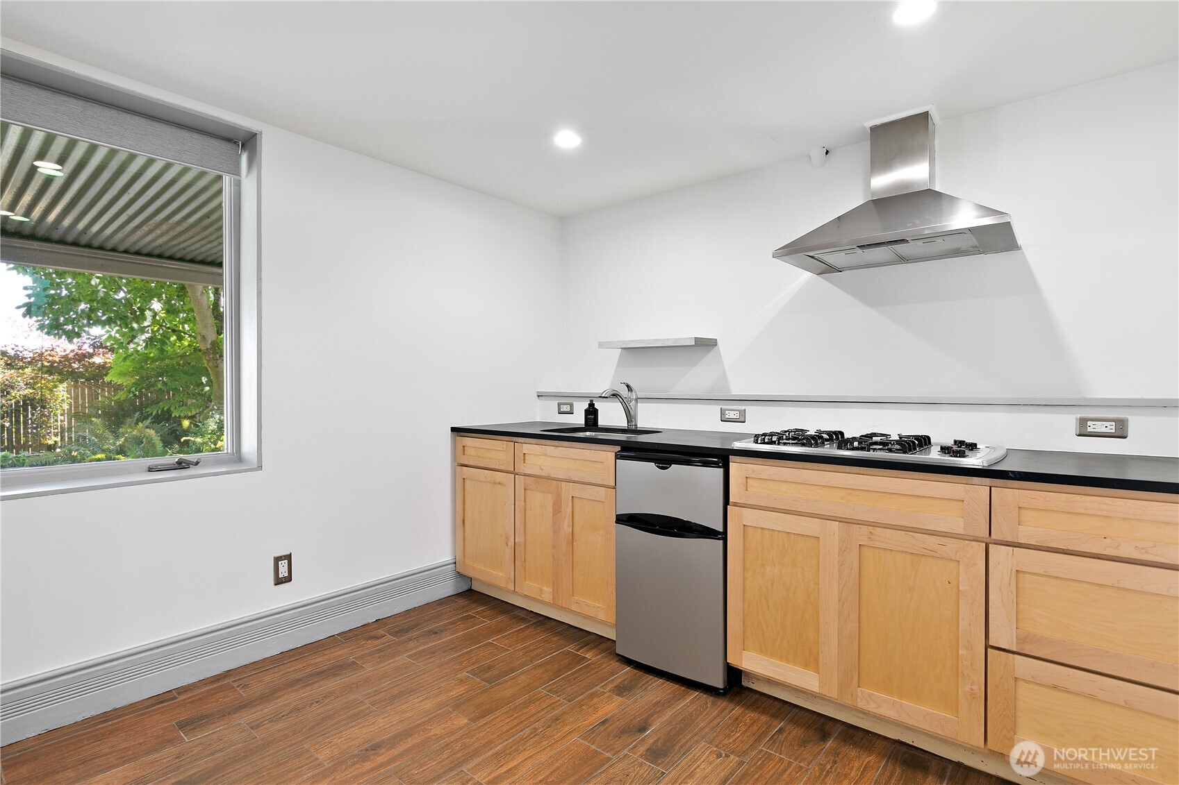 6540 19th Avenue Northeast Seattle, WA 98115 - Photo 23 of 40 a kitchen with granite countertop white cabinets and a wooden floor