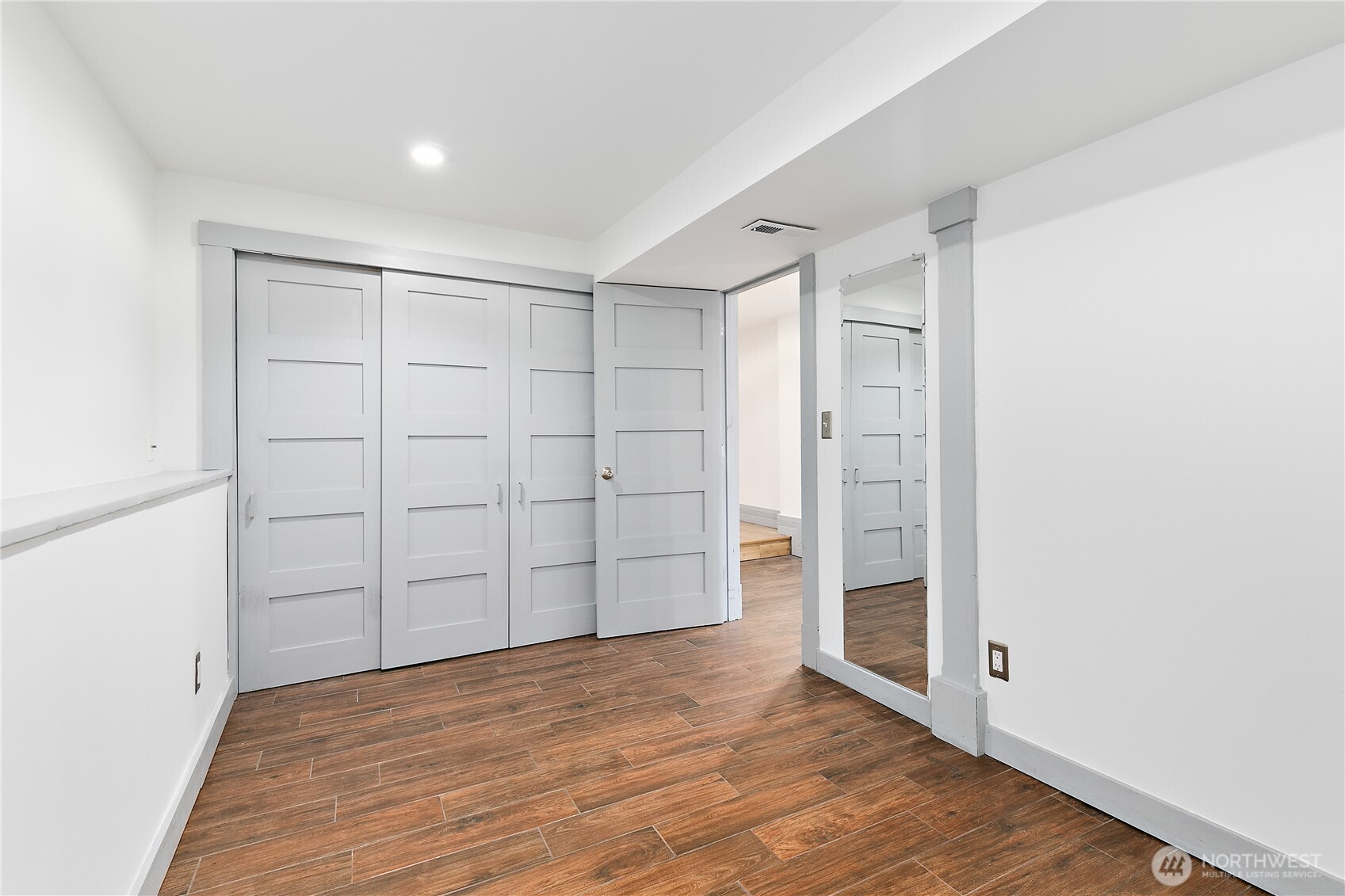 6540 19th Avenue Northeast Seattle, WA 98115 - Photo 27 of 40 an empty room with wooden floor and closet area