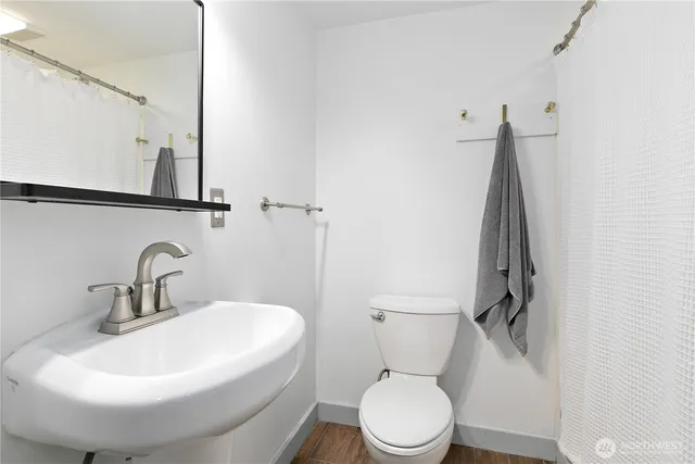 a white toilet sitting next to a bathroom sink