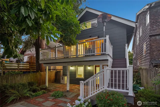 a view of a house with brick walls and plants