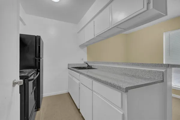 a kitchen with a sink and a refrigerator