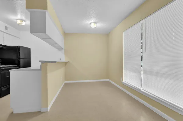 a view of a livingroom with an empty space and a window