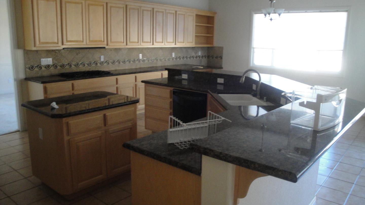 309 Carrick Circle Hayward, CA 94542 - Photo 11 of 12 a kitchen with granite countertop white cabinets and black appliances