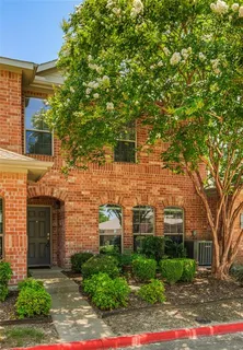a view of a brick house with a large windows