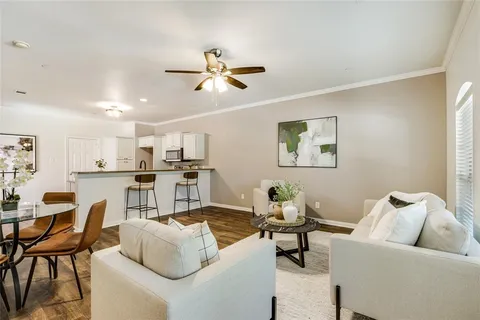 a living room with furniture and kitchen view