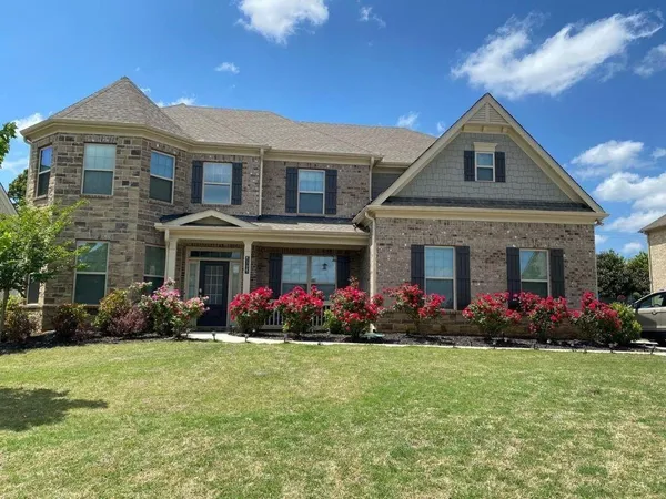a front view of a house with garden