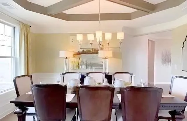 a view of a dining room with furniture and window