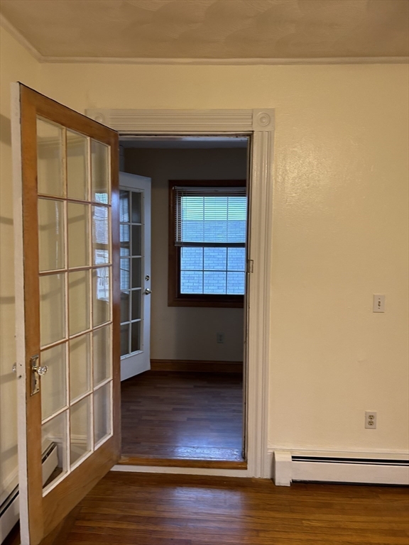 25 Baltimore Street, Unit 2/3 Lynn, MA 01902 - Photo 11 of 36 a view of an empty room and wooden floor and cabinet